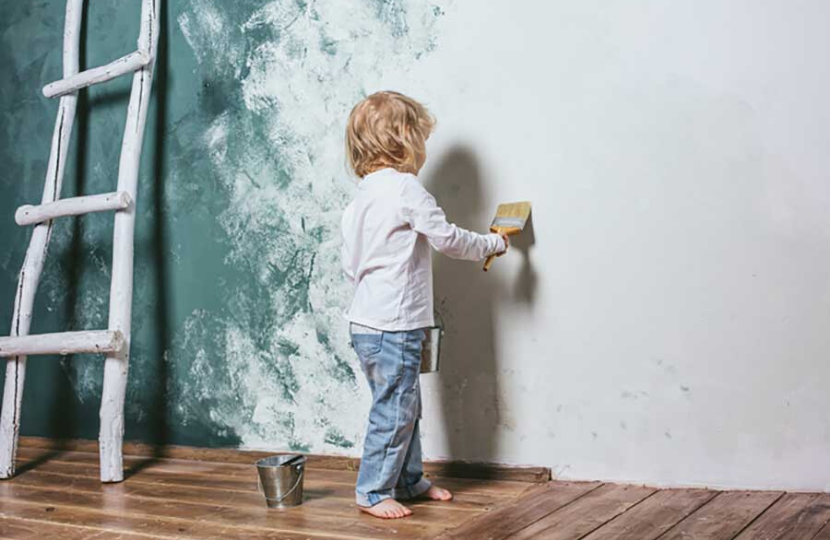 niño pintando pared